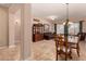 Elegant dining room with travertine flooring seamlessly flowing into the open-concept living space at 1526 E Hazel Dr, Phoenix, AZ 85042