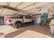 Spacious garage with epoxy floors, a pickup truck, and ample storage space at 1526 E Hazel Dr, Phoenix, AZ 85042