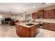 Open-concept kitchen with an island, granite countertops, stainless steel appliances, and a breakfast nook at 1526 E Hazel Dr, Phoenix, AZ 85042