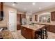 Beautiful kitchen island with granite countertop and a stainless steel refrigerator at 1526 E Hazel Dr, Phoenix, AZ 85042