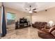 Cozy living room featuring travertine tile flooring and an entertainment area at 1526 E Hazel Dr, Phoenix, AZ 85042