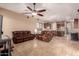 Open living room with travertine flooring connected to the dining and kitchen at 1526 E Hazel Dr, Phoenix, AZ 85042