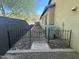 The side yard has an AC unit behind a decorative metal fence and has a view of an outdoor kitchen at 1526 E Hazel Dr, Phoenix, AZ 85042