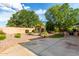 The backyard features desert landscaping, mature trees, a built-in BBQ, and shrubs at 18021 N 53Rd St, Scottsdale, AZ 85254