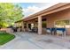 Spacious backyard patio with a built-in grill and ample seating under a covered area at 18021 N 53Rd St, Scottsdale, AZ 85254
