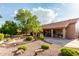 The backyard features desert landscaping, mature trees, and a covered patio at 18021 N 53Rd St, Scottsdale, AZ 85254