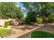 The backyard features desert landscaping, mature trees, and shrubs at 18021 N 53Rd St, Scottsdale, AZ 85254