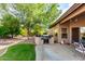 Backyard featuring a built-in grill, patio, beautiful tree, and well maintained lawn at 18021 N 53Rd St, Scottsdale, AZ 85254