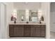 Bathroom featuring double sinks, modern lighting, and a large vanity with dark wood cabinets at 18021 N 53Rd St, Scottsdale, AZ 85254
