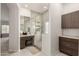 Bathroom featuring a glass shower, vanity area, and storage cabinets at 18021 N 53Rd St, Scottsdale, AZ 85254