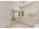 Bedroom featuring carpet, ceiling fan, window, mirrored closet doors, and white walls at 18021 N 53Rd St, Scottsdale, AZ 85254