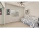 This is a carpeted bedroom with a daybed, ceiling fan and window providing natural light at 18021 N 53Rd St, Scottsdale, AZ 85254