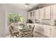 Bright breakfast nook with views of the backyard and modern, neutral décor, next to the kitchen at 18021 N 53Rd St, Scottsdale, AZ 85254