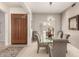 Inviting dining room featuring a glass table and stylish chandelier for elegant dining at 18021 N 53Rd St, Scottsdale, AZ 85254