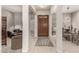 Inviting entryway featuring a wood door, neutral tile flooring, and views into the living and dining areas at 18021 N 53Rd St, Scottsdale, AZ 85254