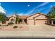 Charming home featuring a spacious three-car garage and well-maintained desert landscaping at 18021 N 53Rd St, Scottsdale, AZ 85254