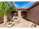 Charming home entrance with beautiful desert landscaping and a cozy front porch at 18021 N 53Rd St, Scottsdale, AZ 85254