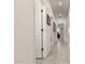 Hallway with white walls and doors, neutral tile floors, and recessed lighting at 18021 N 53Rd St, Scottsdale, AZ 85254