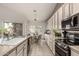 Bright kitchen features white cabinets, modern appliances, and an eat-in dining area with views of the backyard at 18021 N 53Rd St, Scottsdale, AZ 85254