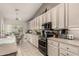 Modern kitchen with white cabinets, stainless steel appliances, and tile flooring at 18021 N 53Rd St, Scottsdale, AZ 85254