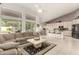 Open-concept living area flowing into the kitchen, featuring tile floors and large windows with backyard views at 18021 N 53Rd St, Scottsdale, AZ 85254