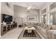 Spacious living room with a high ceiling, tile flooring, and sliding glass door to the backyard at 18021 N 53Rd St, Scottsdale, AZ 85254