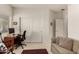 Bright living room featuring a cozy seating area, a desk, and a closet at 18021 N 53Rd St, Scottsdale, AZ 85254