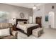 Spacious main bedroom with a seating area, a decorative headboard, and neutral carpet at 18021 N 53Rd St, Scottsdale, AZ 85254