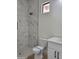 Modern bathroom features a tiled shower with glass enclosure, white vanity with dark hardware, and hexagon-tiled shower floor at 18035 E San Tan Blvd, Queen Creek, AZ 85142