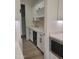 Bright white cabinets, wine rack, mini-fridge, and tiled backsplash complement this modern kitchen space at 18035 E San Tan Blvd, Queen Creek, AZ 85142
