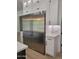 Modern kitchen features a stainless steel refrigerator, white cabinets with dark hardware, and tile backsplash at 18035 E San Tan Blvd, Queen Creek, AZ 85142
