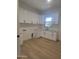 Spacious laundry room with bright white cabinets and countertop space, perfect for all your needs at 18035 E San Tan Blvd, Queen Creek, AZ 85142