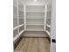 Walk-in pantry with bright, wooden floors and plenty of shelving at 18035 E San Tan Blvd, Queen Creek, AZ 85142
