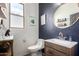 Stylish powder room featuring a dark accent wall and modern fixtures at 1835 S Rockwell St, Gilbert, AZ 85295