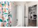 Bright bathroom featuring a shower-tub combo with a modern showerhead and a colorful floral shower curtain at 1835 S Rockwell St, Gilbert, AZ 85295
