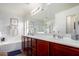 Bright bathroom featuring a soaking tub, shower, and dual sinks at 1835 S Rockwell St, Gilbert, AZ 85295
