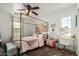 Inviting bedroom features a four-poster bed, a desk, and abundant natural light from the window at 1835 S Rockwell St, Gilbert, AZ 85295