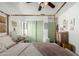 Bright bedroom with a four-poster bed, a desk, and ample storage with sliding closet doors at 1835 S Rockwell St, Gilbert, AZ 85295