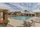 Sparkling community pool, surrounded by lounge chairs and tables, perfect for relaxing and enjoying the sunshine at 1835 S Rockwell St, Gilbert, AZ 85295