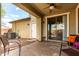 Outdoor patio area showcasing ample seating, ceiling fan and sliding glass doors leading to the home's interior at 1835 S Rockwell St, Gilbert, AZ 85295