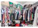 Spacious walk-in closet with shelving, hanging rods, and ample storage space for clothing and accessories at 1835 S Rockwell St, Gilbert, AZ 85295