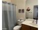 Clean bathroom featuring a shower with a curtain, vanity, and toilet for convenience and functionality at 18427 E Verde Ct, Gold Canyon, AZ 85118