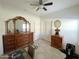 Bright bedroom features tiled floors, a ceiling fan, and classic furniture for a comfortable, serene space at 18427 E Verde Ct, Gold Canyon, AZ 85118