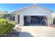 Charming home exterior with a well-maintained yard and an open garage at 18427 E Verde Ct, Gold Canyon, AZ 85118