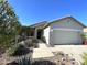 Single-story home with manicured front yard landscaping, two car garage, and a covered front porch at 18427 E Verde Ct, Gold Canyon, AZ 85118