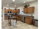 Well-lit kitchen with wooden cabinets, stainless steel appliances, and a central island for functionality at 18427 E Verde Ct, Gold Canyon, AZ 85118