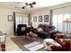 Inviting living room with a brown rug, leather sofa, and a ceiling fan for a relaxing ambiance at 18427 E Verde Ct, Gold Canyon, AZ 85118