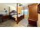Elegant main bedroom with a four-poster bed, wooden furniture, and plantation shutters for added privacy at 18427 E Verde Ct, Gold Canyon, AZ 85118