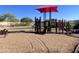 Community playground area with several structures, horse spring riders, and a red shade canopy above at 18427 E Verde Ct, Gold Canyon, AZ 85118