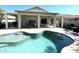 Inviting backyard featuring a sparkling pool, covered patio, and comfortable outdoor seating at 18427 E Verde Ct, Gold Canyon, AZ 85118